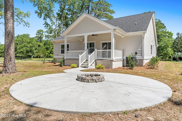 4039 Pintail Ave, Shallotte, NC 28470 - view of front of house with a fire pit, a ceiling fan, roof with shingles, a porch, and a front yard