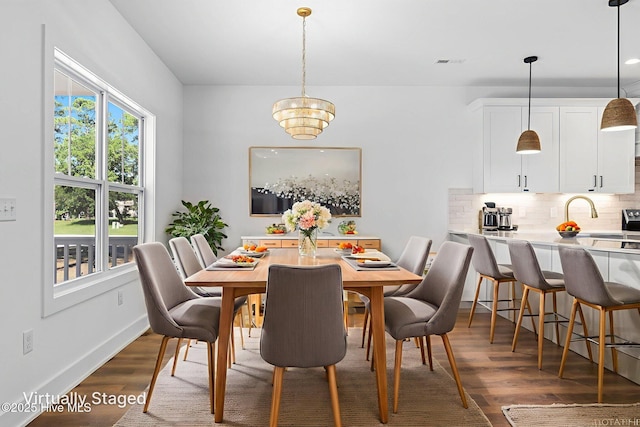 4039 Pintail Ave, Shallotte, NC 28470 - dining area featuring wood finished floors and a chandelier