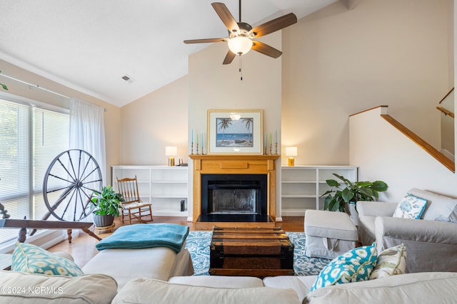 living room with ceiling fan, high vaulted ceiling, and light wood-type flooring