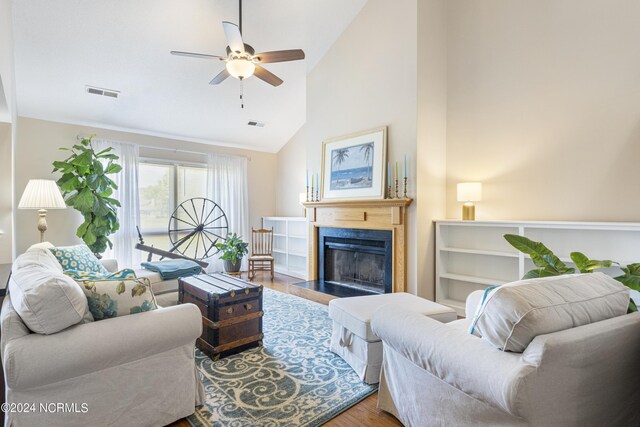 living room featuring ceiling fan, high vaulted ceiling, and wood-type flooring