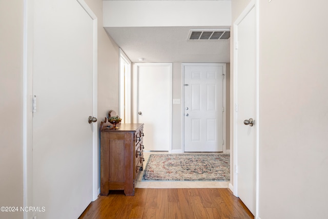 interior space with a textured ceiling and hardwood / wood-style flooring