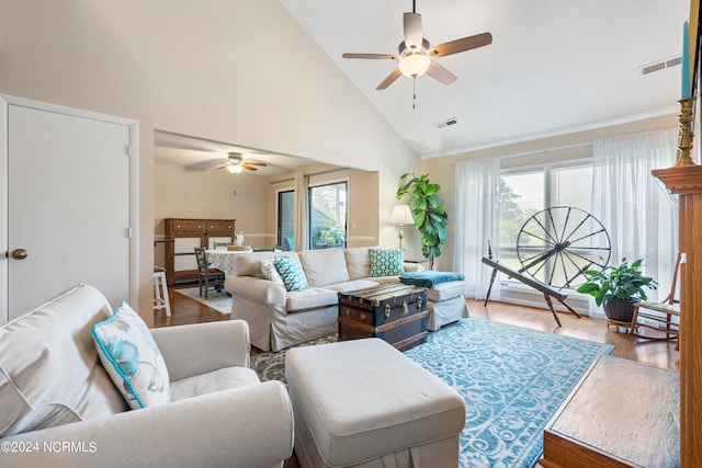 living room with ceiling fan, high vaulted ceiling, plenty of natural light, and hardwood / wood-style floors