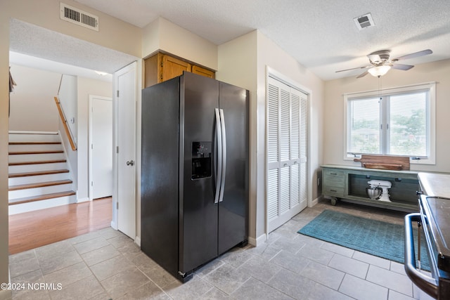 kitchen featuring a textured ceiling, ceiling fan, and stainless steel fridge with ice dispenser