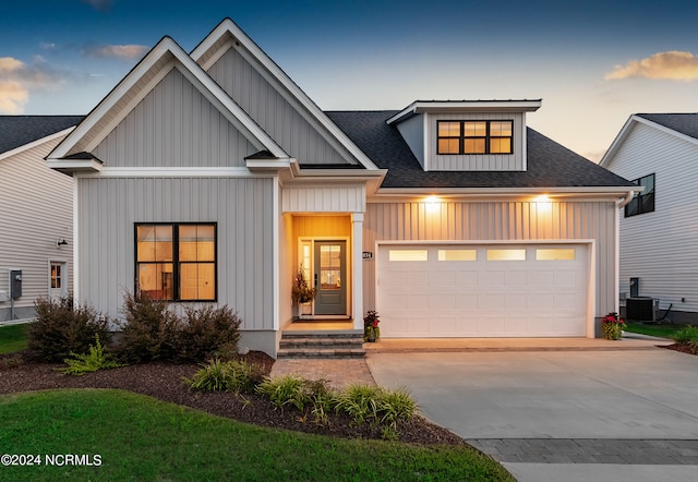 view of front of property with cooling unit and a garage