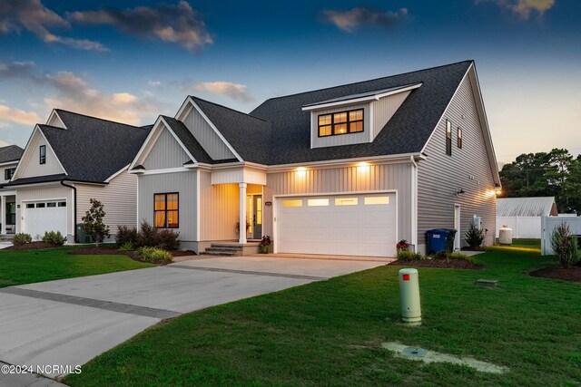 view of front facade featuring a yard and a garage