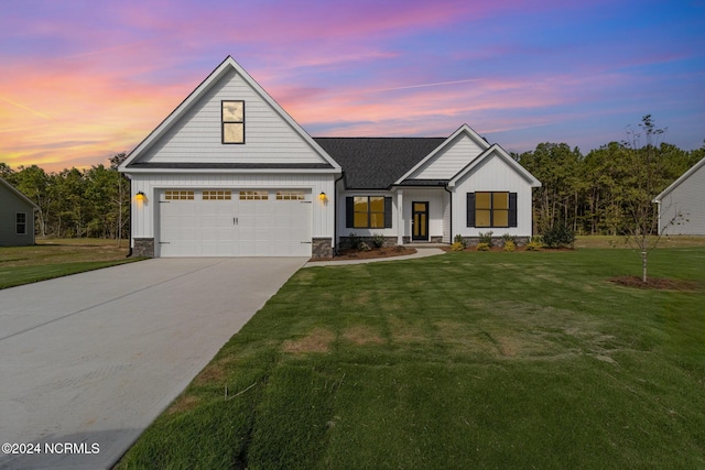 view of front facade with a garage and a lawn