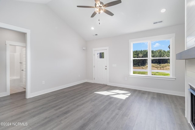 unfurnished living room featuring hardwood / wood-style flooring, ceiling fan, and vaulted ceiling