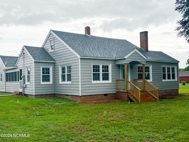 back of house with a yard