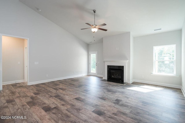 unfurnished living room featuring a ceiling fan, wood finished floors, high vaulted ceiling, a fireplace with flush hearth, and baseboards