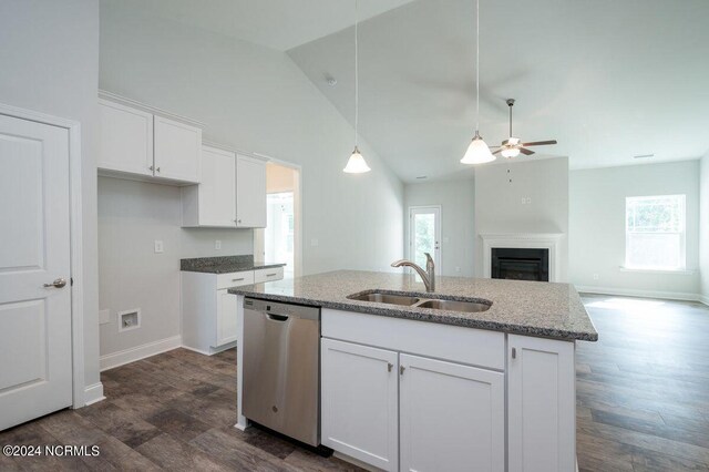 1213 St Simons Dr SE, Bolivia, NC 28422 - kitchen with stainless steel dishwasher, a sink, a ceiling fan, light stone countertops, and high vaulted ceiling