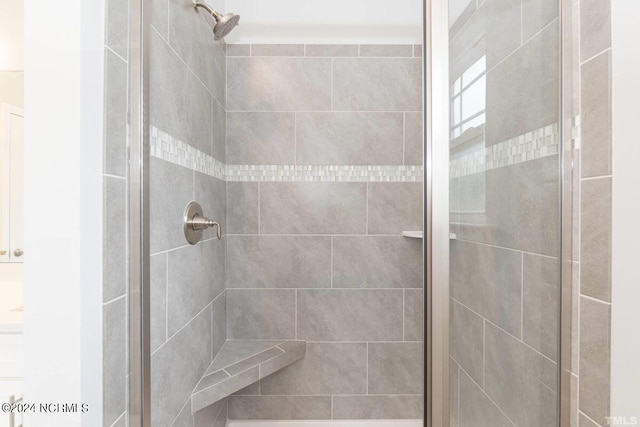 full bath with a shower stall
