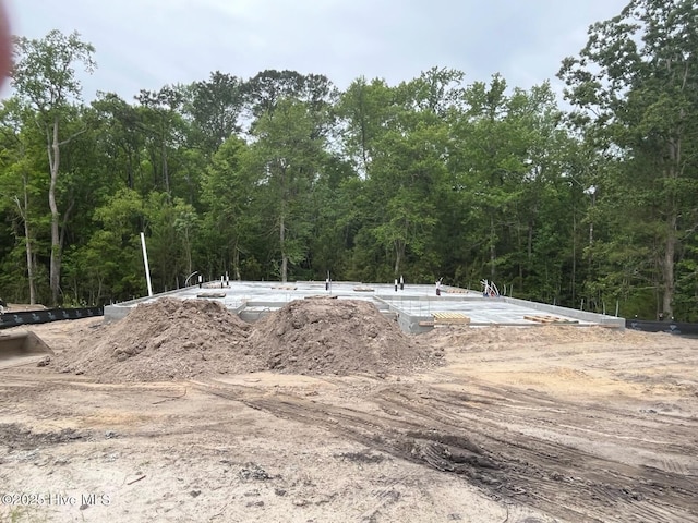 view of storm shelter featuring a wooded view
