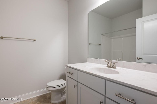 full bath featuring tile patterned flooring, toilet, vanity, baseboards, and walk in shower