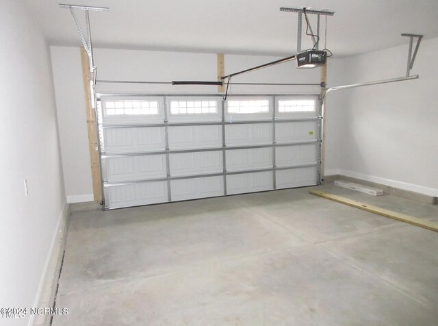 1213 St Simons Dr SE, Bolivia, NC 28422 - garage featuring a garage door opener and baseboards