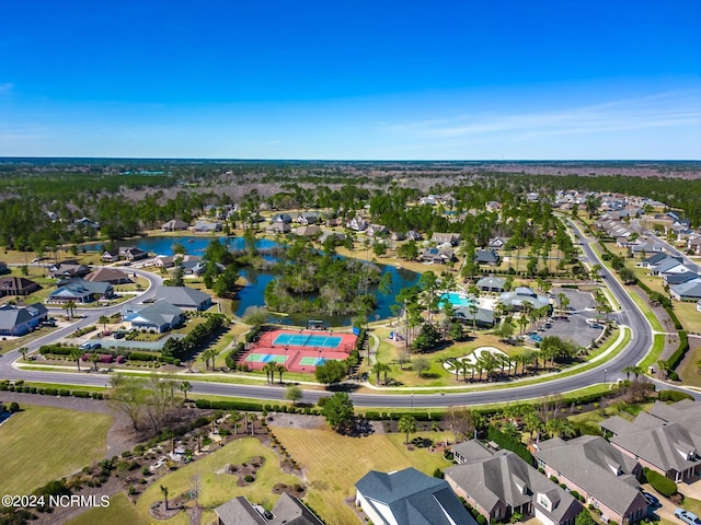 aerial view of property's location with a large body of water and nearby suburban area