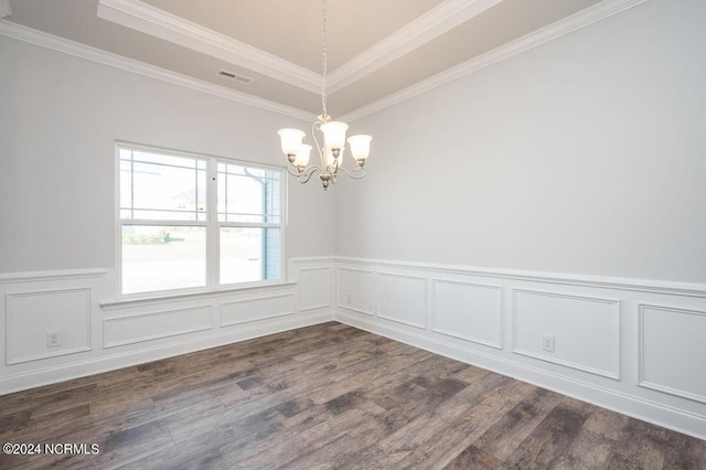 unfurnished room with a chandelier, a raised ceiling, dark wood-type flooring, a wainscoted wall, and ornamental molding