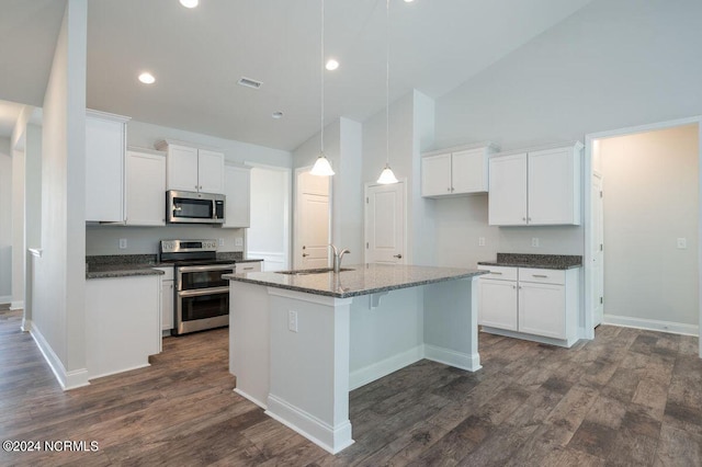 kitchen with stainless steel appliances, a sink, white cabinetry, dark wood-type flooring, and high vaulted ceiling