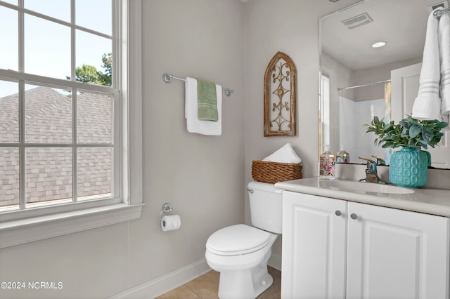 bathroom with a wealth of natural light, walk in shower, toilet, and vanity