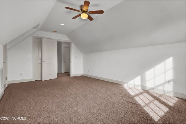 additional living space featuring lofted ceiling, carpet flooring, and ceiling fan