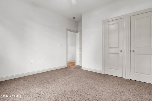 unfurnished bedroom with carpet floors and ceiling fan