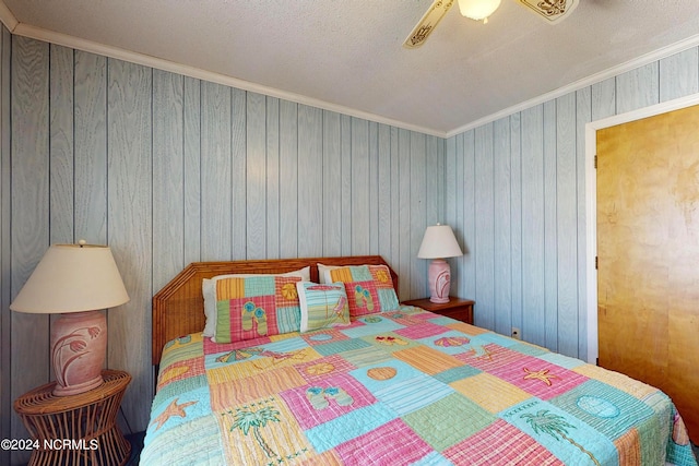 bedroom with ceiling fan, crown molding, and a textured ceiling