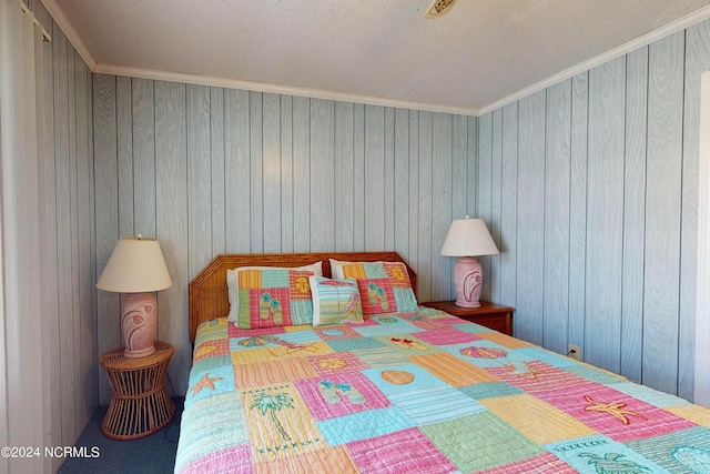 bedroom with a textured ceiling and crown molding