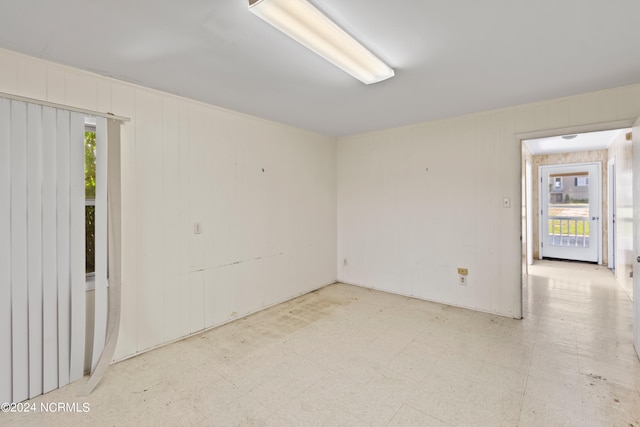 tiled spare room featuring a wealth of natural light