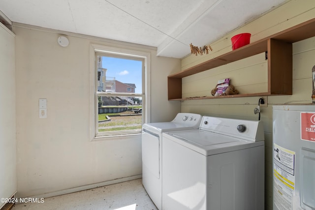 washroom featuring washing machine and dryer and electric water heater