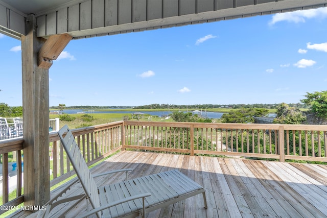 wooden terrace featuring a water view