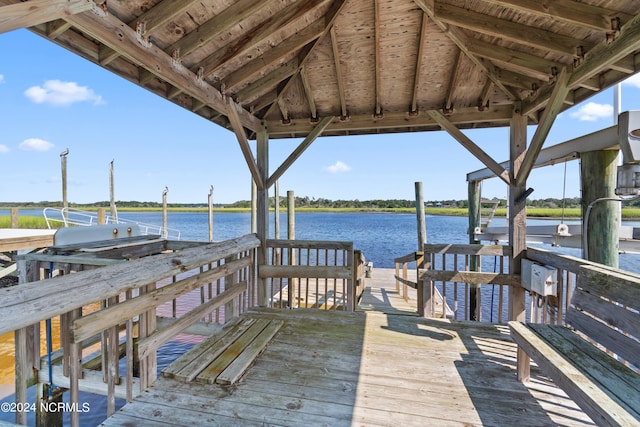 view of dock featuring a gazebo and a water view