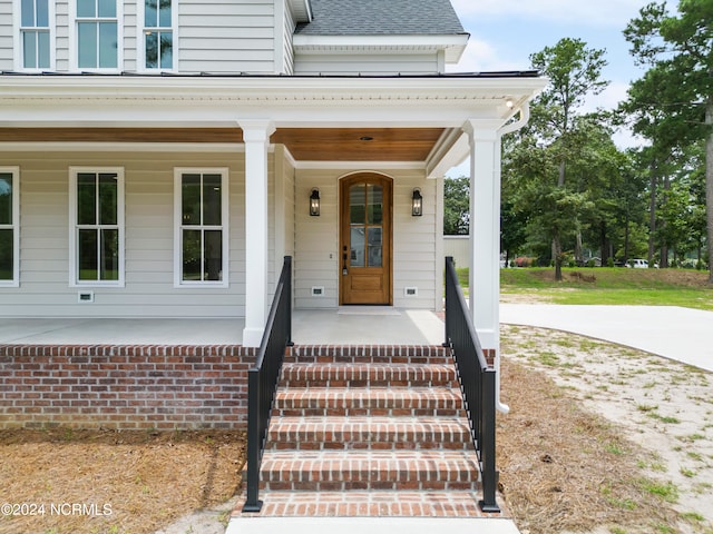 doorway to property with a porch