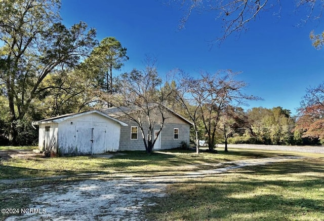 view of side of property with a yard