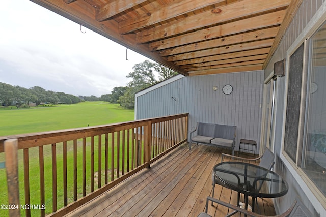 wooden deck featuring a lawn