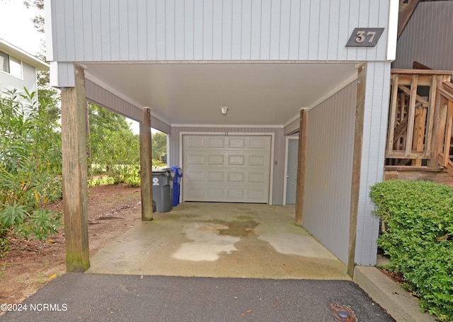 garage with a carport and driveway