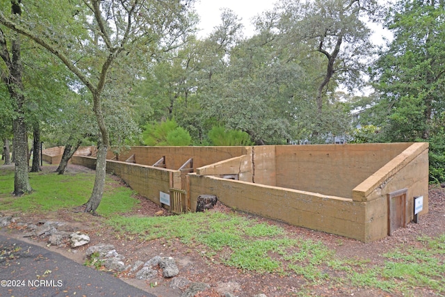 view of side of home featuring fence