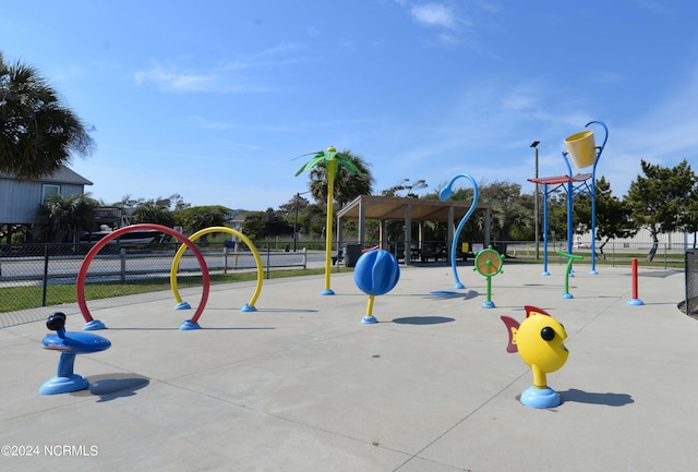 view of home's community with playground community and fence