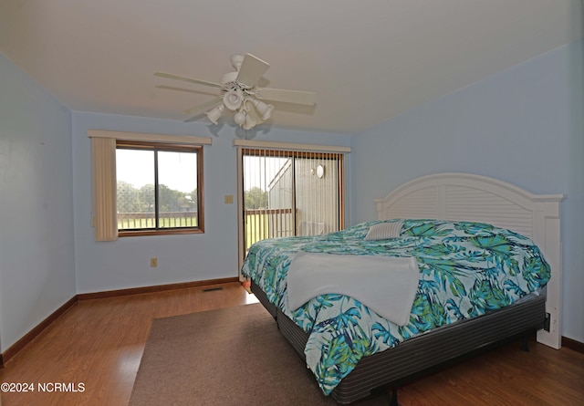 bedroom featuring access to exterior, ceiling fan, baseboards, and wood finished floors