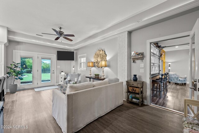 living room featuring ceiling fan, french doors, hardwood / wood-style flooring, and a tray ceiling