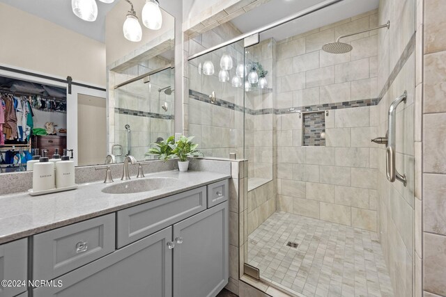 bathroom with vanity and a shower with shower door