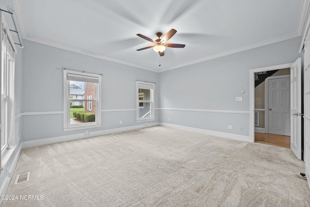 unfurnished bedroom featuring light carpet, ornamental molding, and ceiling fan