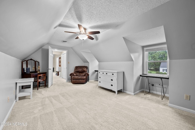 additional living space with ceiling fan, vaulted ceiling, a textured ceiling, and light carpet