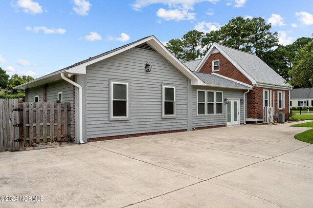 back of house with a patio, central AC unit, fence, and brick siding