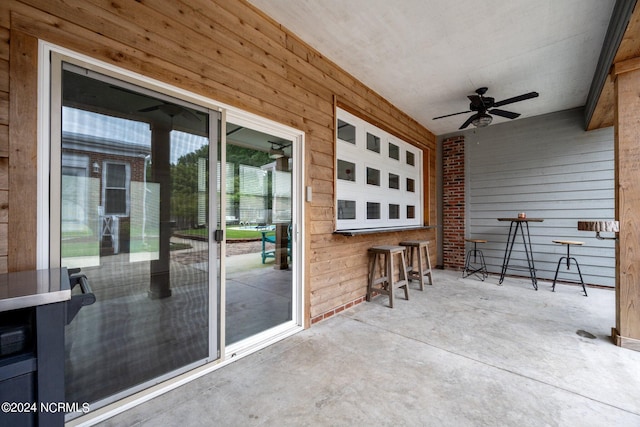 view of patio featuring outdoor dry bar and a ceiling fan