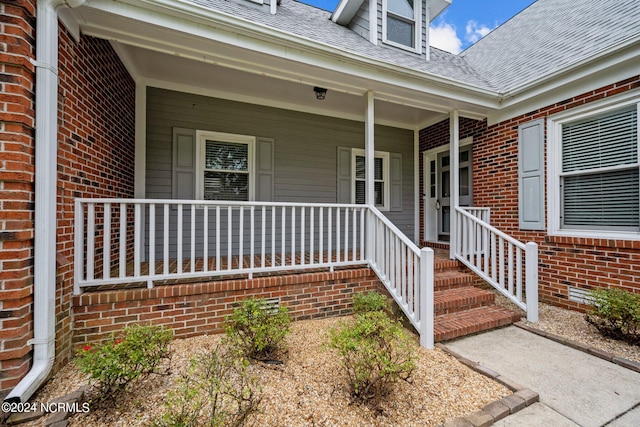 view of exterior entry with covered porch