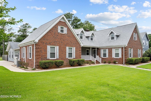 new england style home with a porch and a front yard