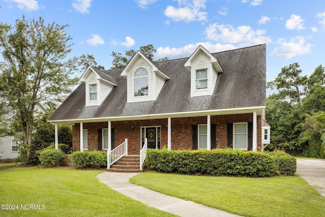 cape cod-style house with covered porch and a front lawn