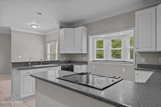 kitchen featuring white cabinets, sink, light tile patterned floors, and a healthy amount of sunlight