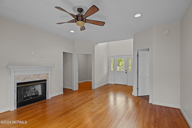 unfurnished living room featuring ceiling fan and light wood-type flooring