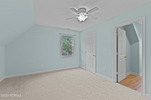 additional living space with ceiling fan, carpet, and lofted ceiling