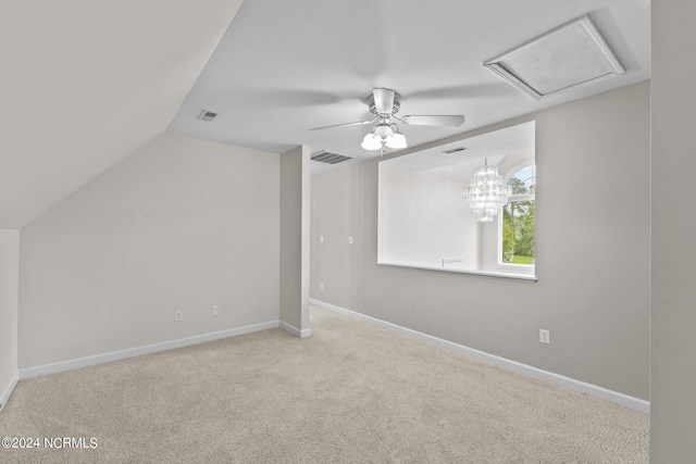 additional living space with vaulted ceiling, ceiling fan with notable chandelier, and light carpet